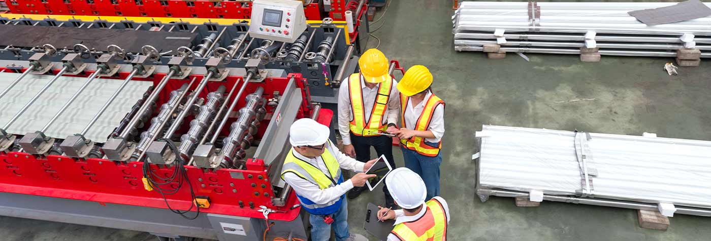 senior engineer manager trains new employees within the metal sheet factory